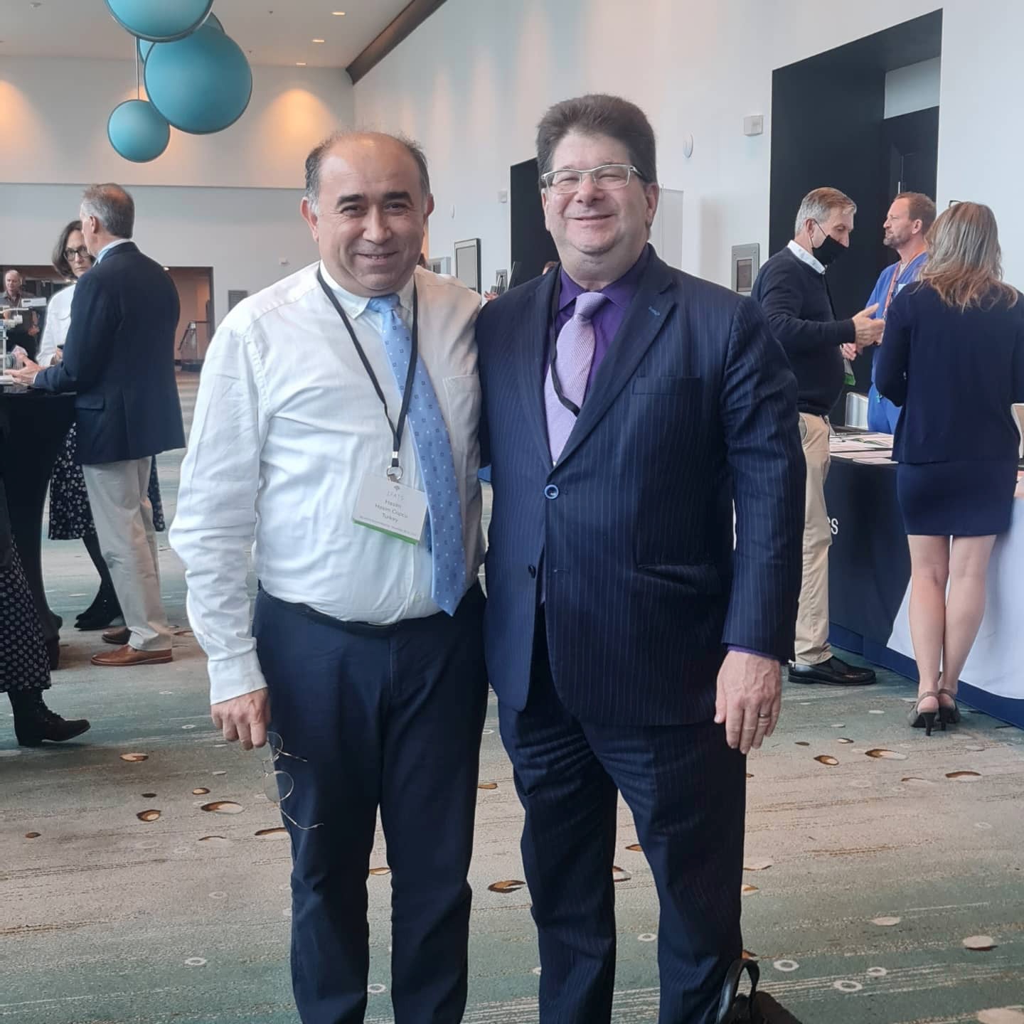 Copcu with a colleague in the conference foyer
