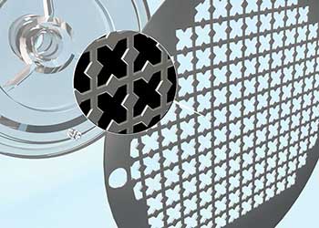 Close-up of a perforated screen with the cross-shaped apertures tissue is passed through